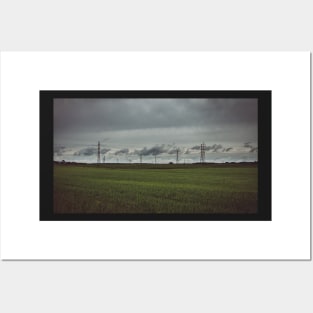 Moody sky over meadow and power lines Posters and Art